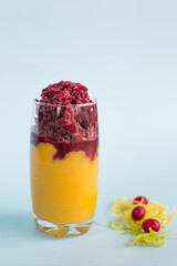 Healthy cold summer exotic smoothie with fruits and raspberries