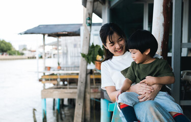 Happy moment of asian family mother and  kid spending time together at the park. Son and mom have fun enjoy family time at weekend. Lifestyle moments. Childhood and weekend concept