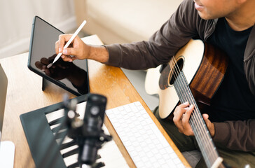 Close up hands song writer composing music note on tablet. Professional composer Recording Mixing...