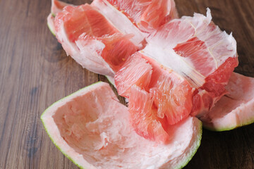 Fresh red pomelo fruit or grapefrui on wooden background