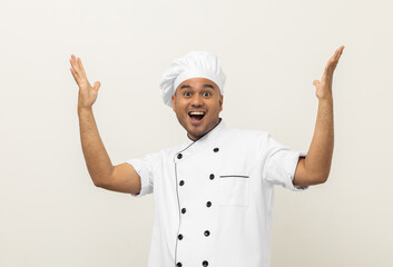 Happy Smiling Young handsome asian man chef in uniform arms stretch feeling successful excited on...