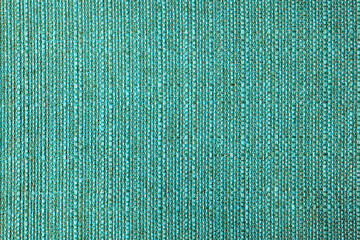 Close-up texture of natural turquoise coarse weave fabric or cloth. Fabric texture of natural cotton or linen textile material. Blue canvas background. Decorative fabric for upholstery, furniture, wal