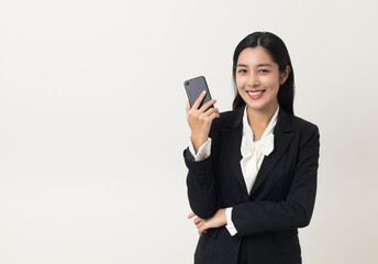 Happy young asian business woman using smartphone on isolated white background. Attractive female...