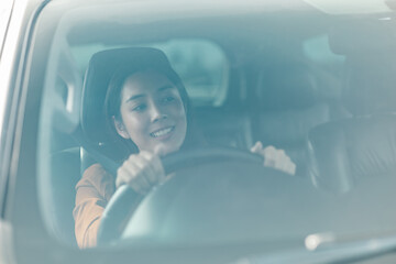 Young beautiful asian women getting new car. she very happy and excited. Smiling female driving...