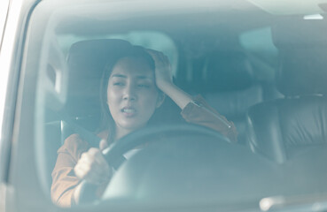 Young asian woman has broken down car on the road she feeling serious and stressed.Look for someone...