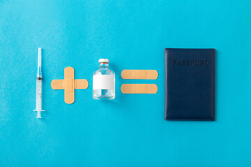 travel, vaccination and healthcare concept - disposable syringe, medicine, patches and immunity passport on blue background