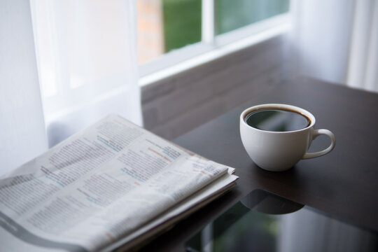 Coffee Cup And Newspaper On Office Desk