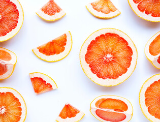Essential oil bottle with  grapefruit slices on white background.