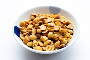 Roasted peanuts on white background.