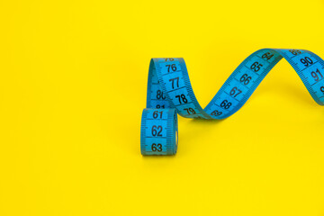 Spiral tape measure colorful background with copyspace