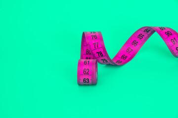 Spiral tape measure colorful background with copyspace