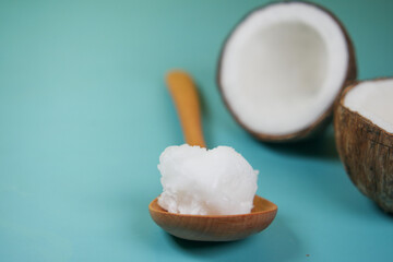 Fototapeta na wymiar spoon with cold coconut oil on table 