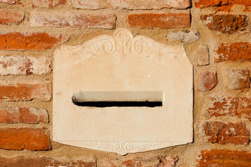 Old mailbox on a red brick wall as bakground