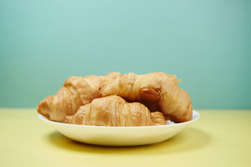 fresh baked croissant on plate with copy space 