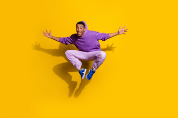 Fototapeta na wymiar Full length body size view of handsome trendy cheerful guy jumping fooling isolated on bright yellow color background