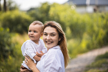 Mom spends time with her son. Happy motherhood. Mom and her baby. Smiling mother and her son.