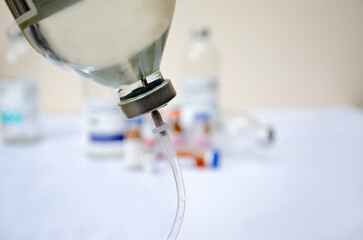 Close up of medical drip ordrip chamber in patient room. Healthcare concept, 