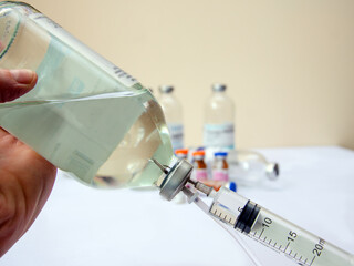 Close up of medical drip ordrip chamber in patient room. Healthcare concept, 