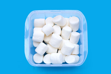 Delicious white marshmallows on blue background.
