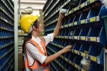 Portrait Asian women staff worker Standing counting and inspecting products in the warehouse.
