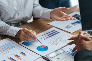 Business people working in the office discussing documents and ideas at meeting, Asian business advisor meeting to analyze and discuss the situation on the financial report.