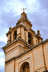 Fototapeta na wymiar Church tower with belfry. Photo taken in Mdina or the Silent City. Malta, Europe.