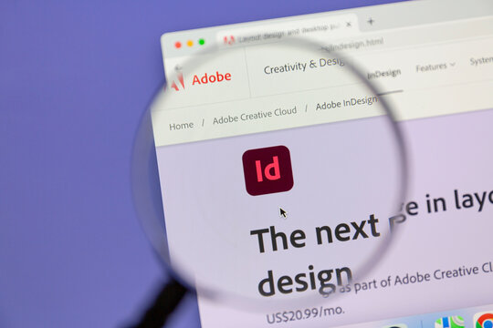 Ostersund, Sweden - July 4, 2022: Adobe InDesign website under a magnifying glass. Adobe InDesign is a desktop publishing and page layout designing software application produced by Adobe.