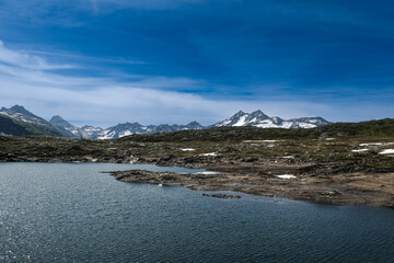 A picture with noise effect added of Totensee Lake and mountain with snow in afternoon.