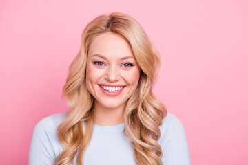 Photo of satisfied glad young girl toothy beaming smile look camera isolated on pink color...