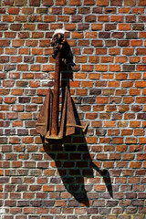 silhouette of a person on a brick wall