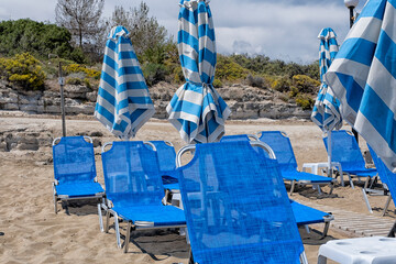 Blue and white sunbeds and parasols