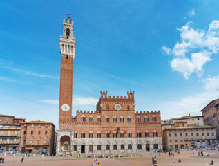 Fototapeta na wymiar Mangia Tower in Piazza del Campo in historic city Siena, Tuscany, Italy