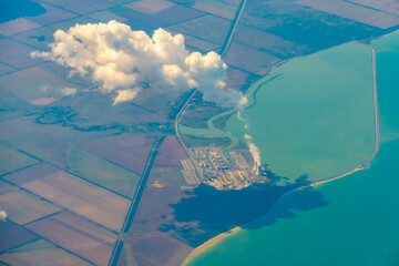 Aerial photo of Farmland. view from the plane to the ground. squares of fields under the clouds