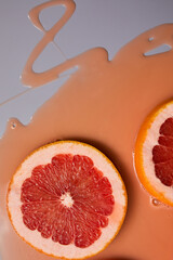 Top view of fresh slice grapefruits juice and gel serum, organic cosmetics,