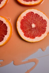 Top view of fresh slice grapefruits juice and gel serum, organic cosmetics,