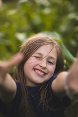 A child on a farm. A cheerful and happy child is playing on the farm. Happy childhood. Farm life.