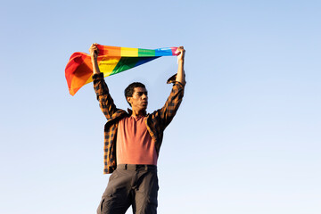 Happy man with a pride flag. LGBT community..