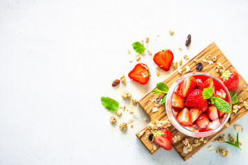Parfait with cream and fresh strawberries in the glass jar. Top view with copy space.