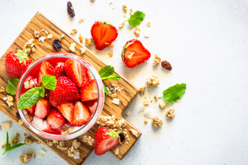 Parfait with cream or yogurt and fresh berries in the glass jar. Top view.