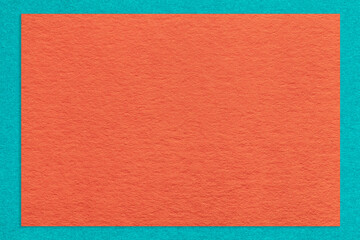 Texture of craft orange color paper background with cerulean border, macro. Structure of vintage dense kraft cardboard