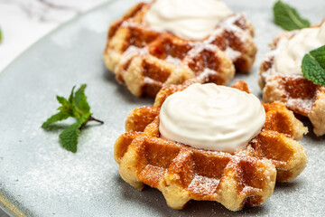 belgian waffles with icing sugar and Whipped Cream. Culinary, cooking, bakery concept. Food recipe background. Close up