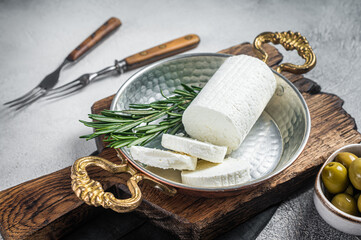 Fototapeta na wymiar Goat soft cheese chevre in a skillet. White background. Top view