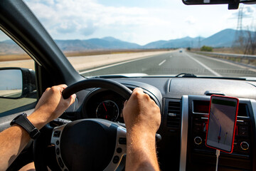 man hands on steering wheel car travel concept