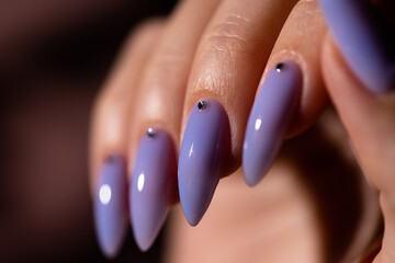 Beautiful long nails in sky blue color decorated by crystals 