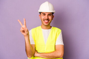 Young hispanic worker man isolated on purple background showing number two with fingers.