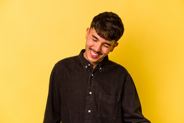 Young caucasian man isolated on yellow background dancing and having fun.