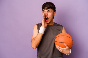 Young hispanic basketball player man isolated on purple background is saying a secret hot braking...