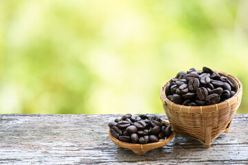 Fototapeta na wymiar Coffee seeds in basket on nature background.