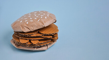 Cheeseburger made from cardboard. Unhealthy eating or fast food concept