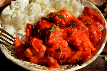 Chicken tikka masala with rice on a plate
